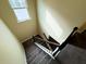 View looking down the carpeted stairs with black metal and wood handrail and natural light at 11978 Quail Rd, Hampton, GA 30228