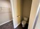 Toilet room features a toilet, roll holder and partial view of the shower at 11978 Quail Rd, Hampton, GA 30228