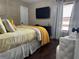 A comfortable bedroom features warm yellow accents, a cozy chair, hardwood floors and soft natural light at 3302 Willow Meadow Ln, Douglasville, GA 30135