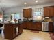 Inviting kitchen with brown cabinetry, stainless steel appliances, granite counters, and cozy island at 3302 Willow Meadow Ln, Douglasville, GA 30135