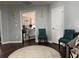 Cozy living room area with hardwood floors, two teal chairs, and an entrance to another room at 3302 Willow Meadow Ln, Douglasville, GA 30135