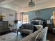 Bright and airy main bedroom with hardwood floors, ceiling fan, and a comfortable sitting area at 3302 Willow Meadow Ln, Douglasville, GA 30135