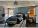 Stylish main bedroom with hardwood floors, ceiling fan, and a comfortable sitting area at 3302 Willow Meadow Ln, Douglasville, GA 30135