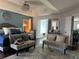 A spacious main bedroom is elegantly staged with a decorative ceiling fan, two stylish sitting chairs, and a comfortable bed at 3302 Willow Meadow Ln, Douglasville, GA 30135