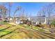 Expansive backyard features lush green grass, mature trees, and a patio with pergola, perfect for outdoor living at 4210 Hamilton Walk Dr, Buford, GA 30519