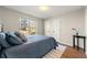 Bedroom with large window providing abundant natural light; includes a queen-size bed and dark wood floors at 4210 Hamilton Walk Dr, Buford, GA 30519