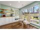 Bright dining area with custom built-ins, hardwood flooring and backyard view at 4210 Hamilton Walk Dr, Buford, GA 30519