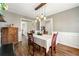 Charming dining area featuring a statement light fixture and access to other living areas at 4210 Hamilton Walk Dr, Buford, GA 30519
