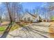 View of a well maintained home with ample parking, detached storage and manicured landscaping at 4210 Hamilton Walk Dr, Buford, GA 30519