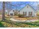 Charming home featuring stone accents, complemented by a beautifully landscaped front yard with mature trees at 4210 Hamilton Walk Dr, Buford, GA 30519