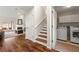 Inviting space with wood floors, fireplace, and staircase leading to the upper level and adjacent laundry room at 4210 Hamilton Walk Dr, Buford, GA 30519