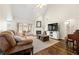 Spacious living room with hardwood floors, fireplace, large windows, and vaulted ceilings at 4210 Hamilton Walk Dr, Buford, GA 30519