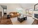 Well-lit living room with hardwood flooring, fireplace, and a view of the outdoor space at 4210 Hamilton Walk Dr, Buford, GA 30519