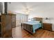 Spacious main bedroom with large window and ensuite bathroom; features wood-look flooring and a ceiling fan at 4210 Hamilton Walk Dr, Buford, GA 30519