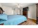 Comfortable main bedroom with ample space, wood-look flooring, ceiling fan and natural light at 4210 Hamilton Walk Dr, Buford, GA 30519