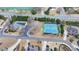 This aerial view shows the tennis courts, a pool, and a parking lot, all within a short distance of residential homes at 5340 Cole Creek Ln, Cumming, GA 30040