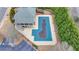 Aerial view showcasing an outdoor neighborhood pool with a deck, covered area with stairs and seating, with lush greenery nearby at 5340 Cole Creek Ln, Cumming, GA 30040
