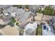 Aerial view of a brick home featuring an attached garage, well-manicured lawn, and mature landscaping in a lovely suburban setting at 5340 Cole Creek Ln, Cumming, GA 30040