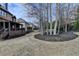 Spacious backyard featuring a covered deck, mature trees, and lush landscaping, perfect for outdoor living and entertaining at 5340 Cole Creek Ln, Cumming, GA 30040