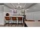 Finished basement bar area with barstool seating and beverage refrigerator at 5340 Cole Creek Ln, Cumming, GA 30040