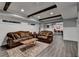 Basement living area with wood beams, recessed lighting, and stylish decor at 5340 Cole Creek Ln, Cumming, GA 30040