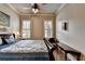Bedroom featuring a bed with a patterned comforter, hardwood floors and natural light at 5340 Cole Creek Ln, Cumming, GA 30040