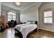 Bedroom featuring hardwood floors, an arched window, and space for a desk area at 5340 Cole Creek Ln, Cumming, GA 30040