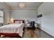 Comfortable bedroom with a decorative chandelier, desk, and hardwood floors at 5340 Cole Creek Ln, Cumming, GA 30040