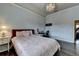 Comfortable bedroom with a decorative chandelier, desk, and hardwood floors at 5340 Cole Creek Ln, Cumming, GA 30040