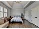 Bright bedroom offers tray ceilings, hardwood floors, and great natural light from the large window at 5340 Cole Creek Ln, Cumming, GA 30040