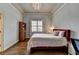 Bedroom featuring hard wood floors, chandelier, and large window at 5340 Cole Creek Ln, Cumming, GA 30040