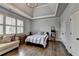 Bright bedroom offers tray ceilings, hardwood floors, and great natural light from large window at 5340 Cole Creek Ln, Cumming, GA 30040