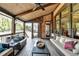 Charming covered patio with wood ceiling, brick accents, ample seating, and an inviting outdoor atmosphere at 5340 Cole Creek Ln, Cumming, GA 30040