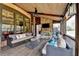 Spacious covered patio featuring a stone fireplace, ceiling fan, and comfortable seating with backyard views at 5340 Cole Creek Ln, Cumming, GA 30040