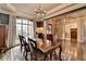 Dining room with decorative rug, chandelier, and large window at 5340 Cole Creek Ln, Cumming, GA 30040