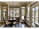 Bright dining room with hardwood floors, a round wood table, and large windows with natural light at 5340 Cole Creek Ln, Cumming, GA 30040