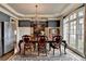 Spacious dining room with hardwood floors, elegant chandelier, and floor to ceiling windows at 5340 Cole Creek Ln, Cumming, GA 30040