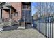 Charming brick home featuring stone accents, a covered porch, an iron fence, and meticulous landscaping at 5340 Cole Creek Ln, Cumming, GA 30040