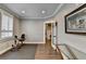 Home gym complete with exercise bike, wood flooring, and adjacent room through a glass paneled door at 5340 Cole Creek Ln, Cumming, GA 30040