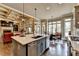 Open-concept kitchen and dining area with stainless steel appliances, island, and hardwood floors at 5340 Cole Creek Ln, Cumming, GA 30040