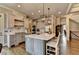 Well-designed kitchen with stainless steel appliances, custom cabinets, and a large island with seating at 5340 Cole Creek Ln, Cumming, GA 30040
