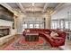 Living room featuring a stone fireplace, red sectional sofa, and coffered ceiling at 5340 Cole Creek Ln, Cumming, GA 30040