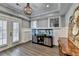 Cozy living room with wainscoting, large windows, and custom built-in aquarium at 5340 Cole Creek Ln, Cumming, GA 30040