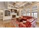 Living room featuring a fireplace, built-in shelving, large windows, and coffered ceiling at 5340 Cole Creek Ln, Cumming, GA 30040