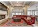 Living room featuring a stone fireplace, red sectional sofa, and coffered ceiling at 5340 Cole Creek Ln, Cumming, GA 30040