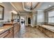 Large main bath with tiled floors, double sink vanity, soaking tub, walk-in closet, and separate entrances at 5340 Cole Creek Ln, Cumming, GA 30040