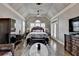 Spacious main bedroom with vaulted ceiling, hardwood floors, chandelier, a ceiling fan, and windows at 5340 Cole Creek Ln, Cumming, GA 30040