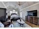Spacious main bedroom with vaulted ceiling, hardwood floors, chandelier, a ceiling fan, and windows at 5340 Cole Creek Ln, Cumming, GA 30040