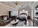 Spacious main bedroom with vaulted ceiling, hardwood floors, chandelier, a ceiling fan, and windows at 5340 Cole Creek Ln, Cumming, GA 30040