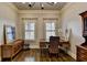 Well-lit office with a wooden desk, hutch, neutral walls, and modern track lighting at 5340 Cole Creek Ln, Cumming, GA 30040